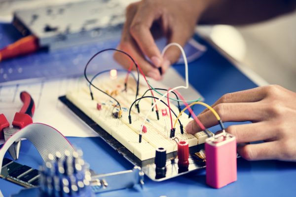 Closeup of hands working on breadboard